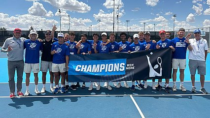 LCU tennis team holding regional champions banner