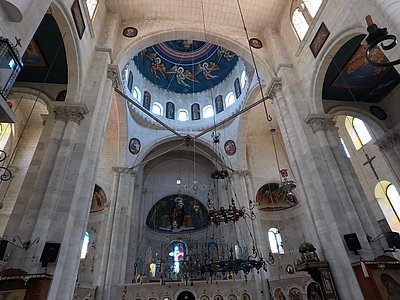 A view of Jacob's Well Nablus in Shkhem looking towards the ceiling showcasing chandelers and candles as well as angles
