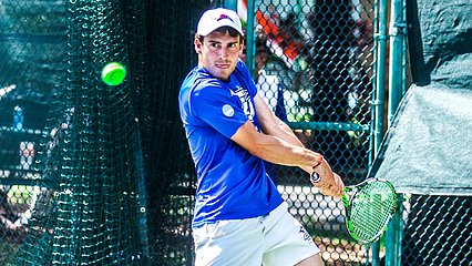 LCU Men's tennis player hitting a ball during elite eight match