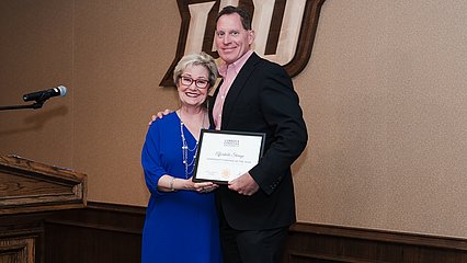 Donna Hammil presenting Michael Postar with the Community Partner of the Year award