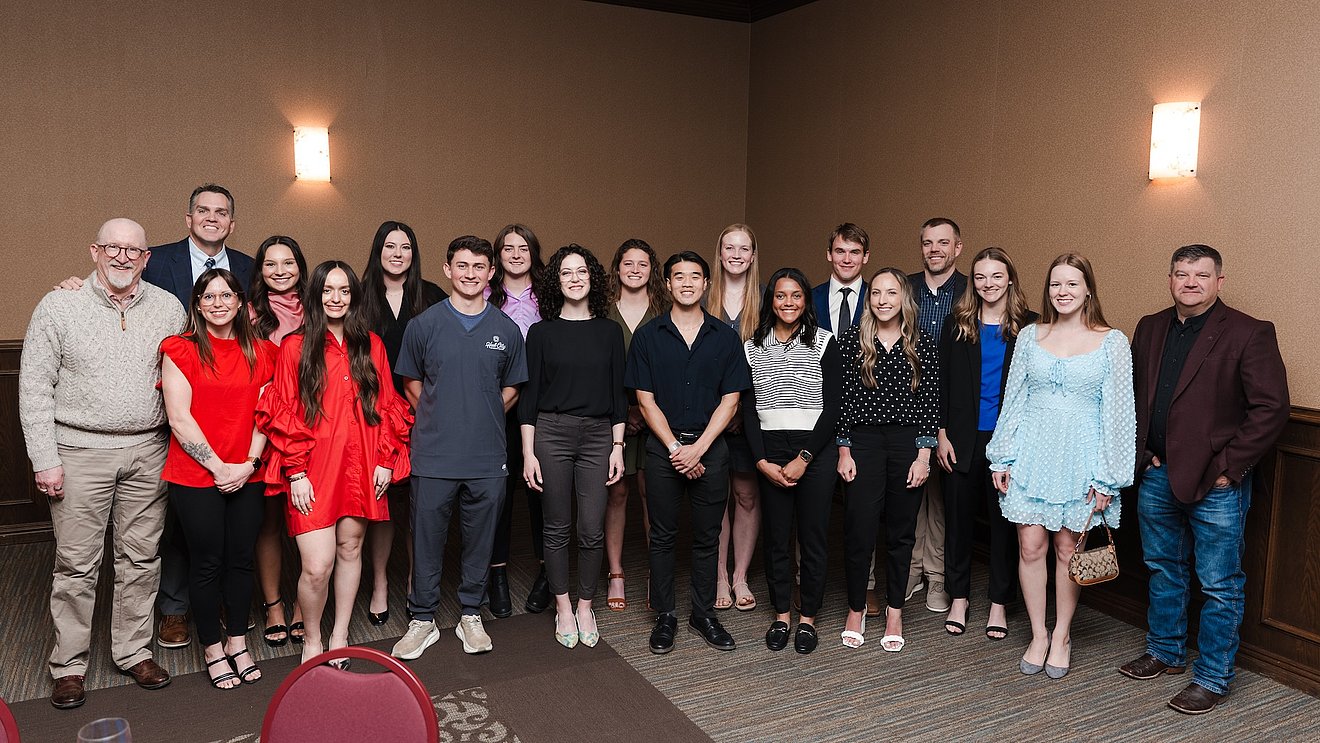 Photograph of students at the dinner with faculty posing as they're recognized for their achievements
