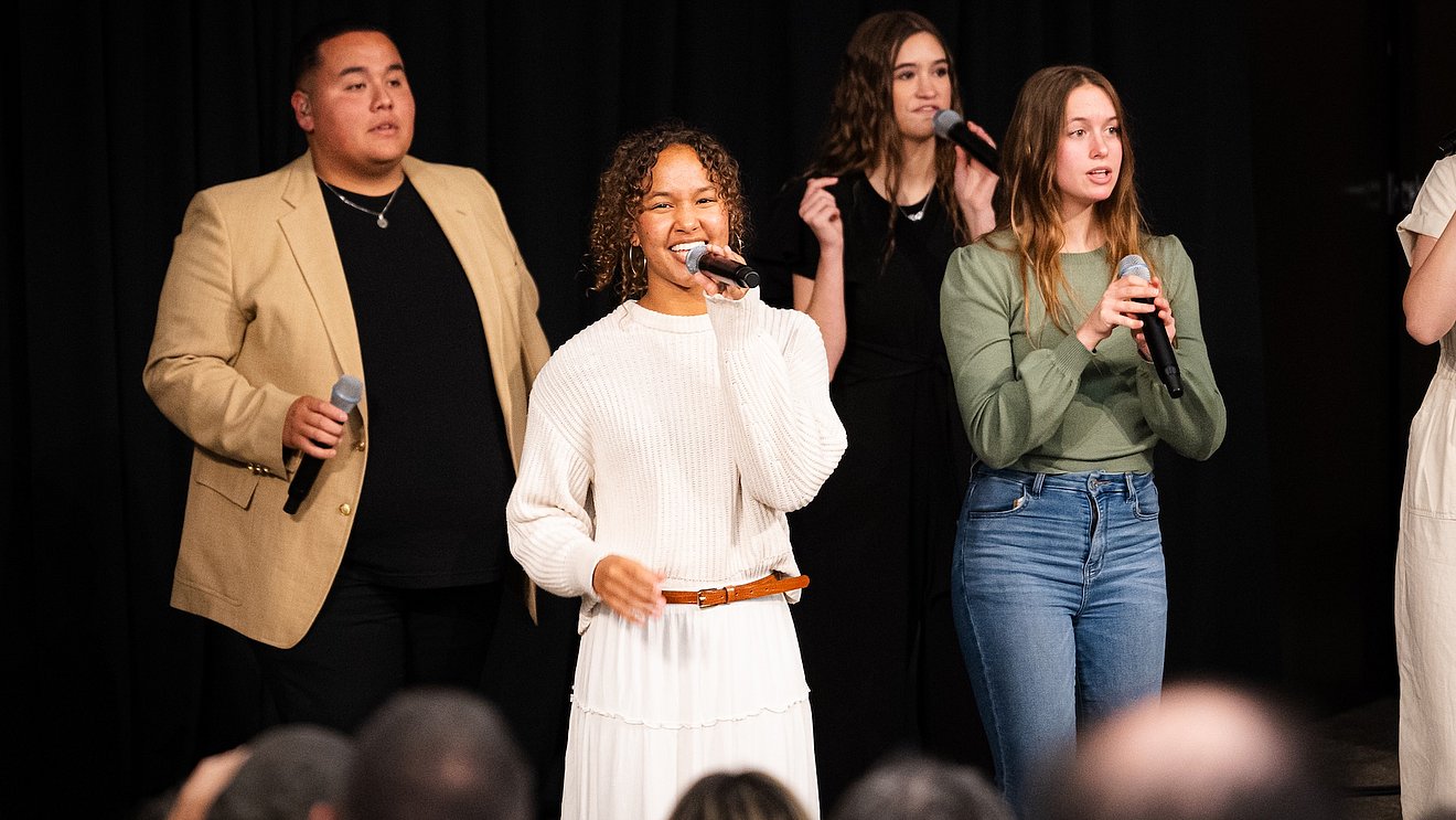 Best Friends singing in a concert venue