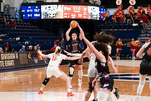 Marty McCoy looks to pass the ball to Audrey Robertson, who is cutting into the lane