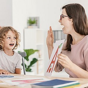 Speech pathologist working with a young child