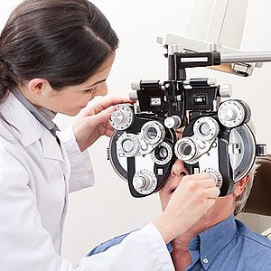 Optometrist performing a vision test on a patient