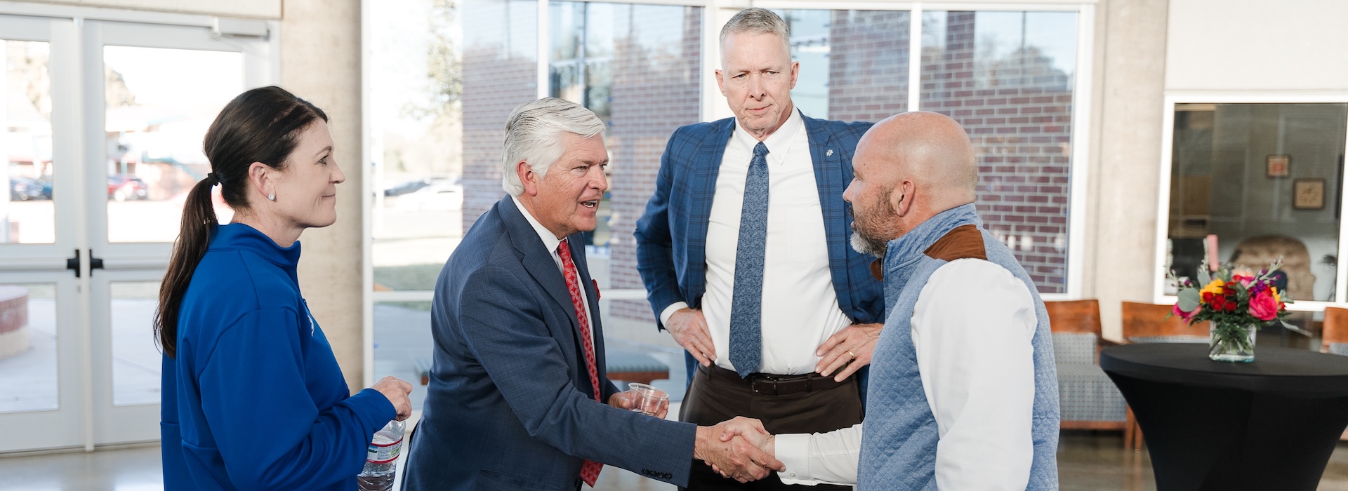Alan Rhodes, chair of the board of trustees, greeting LCU community members