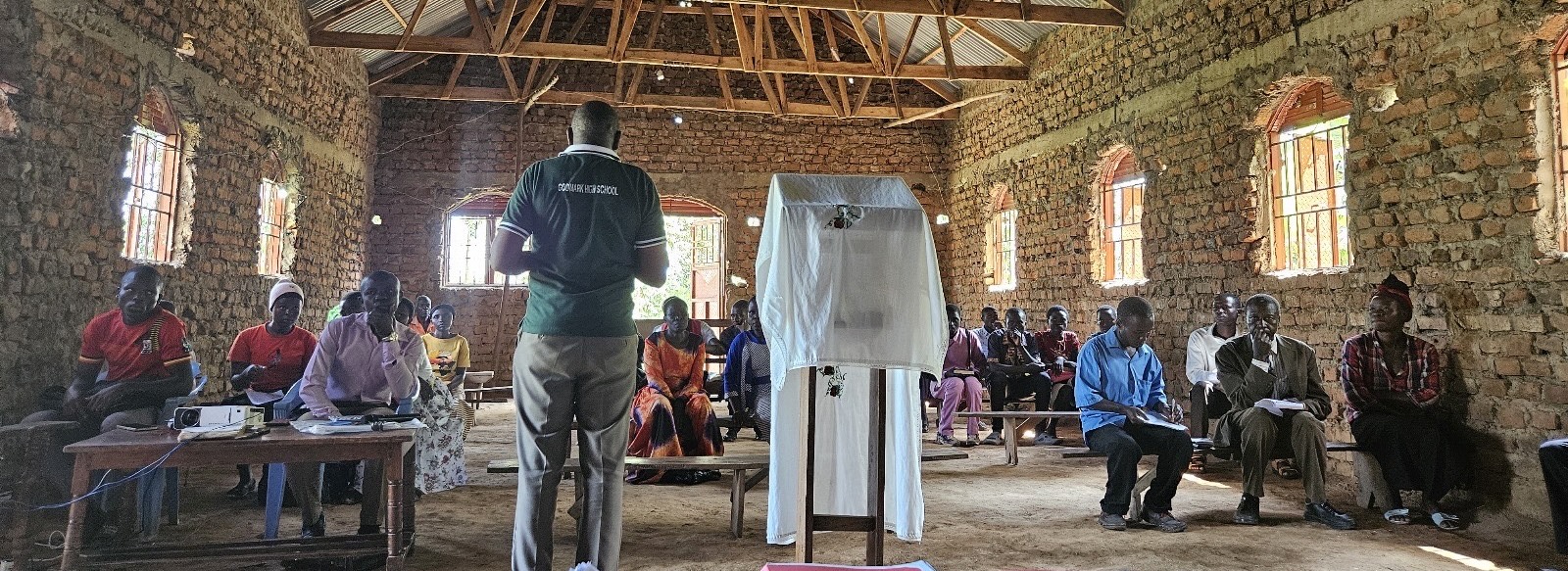 Preacher in Africa in small church with congregation in background