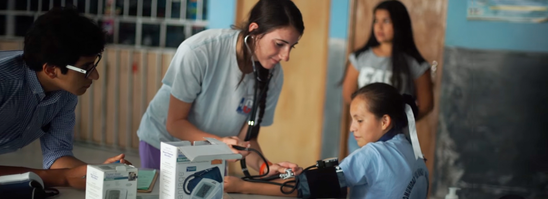 Student checking child's blood pressure