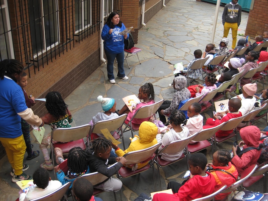 LCU student teaching a group of children on a mission trip
