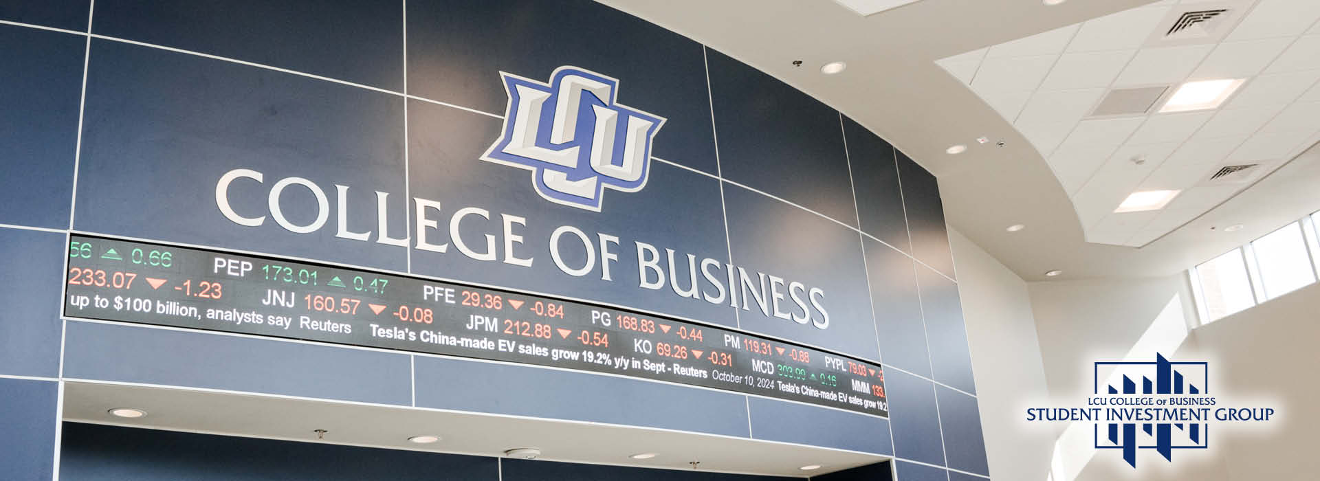 photo of the College of Business atrium with the stock ticker