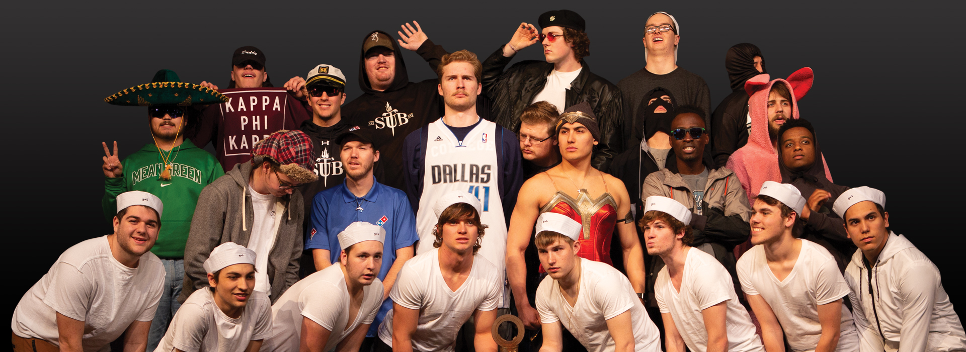 A group of men in Sub T-16 in different costumes looking everywhere but the camera and making silly faces