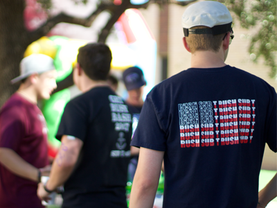 A group of guys in ballcaps hanging out outside