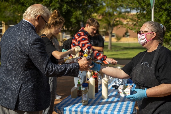 Students and faculty partaking in the carnival food