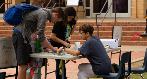 Students participate in writing events at the carnival including magnetic poetry